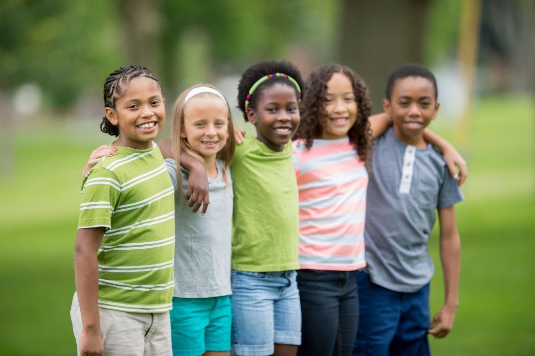 children with arms around each other